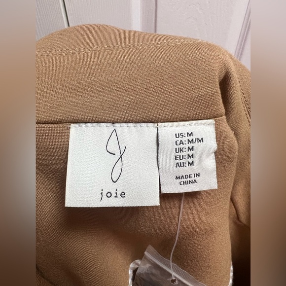 Tan-colored jacket with a structured, tailored design. Gold buttons.Size Medium - Picture 11 of 17